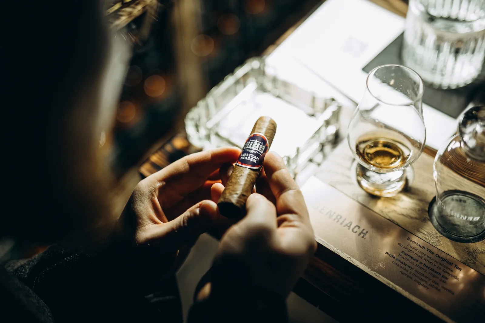 Cygaro i kieliszek alkoholu na stole